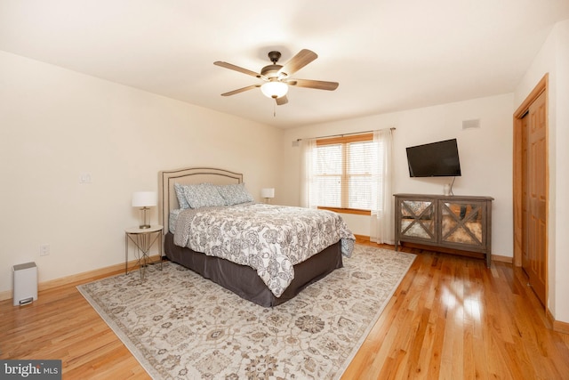 bedroom featuring hardwood / wood-style floors, a closet, and ceiling fan