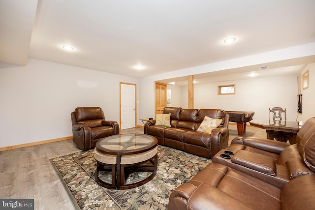 living room with light hardwood / wood-style flooring and billiards