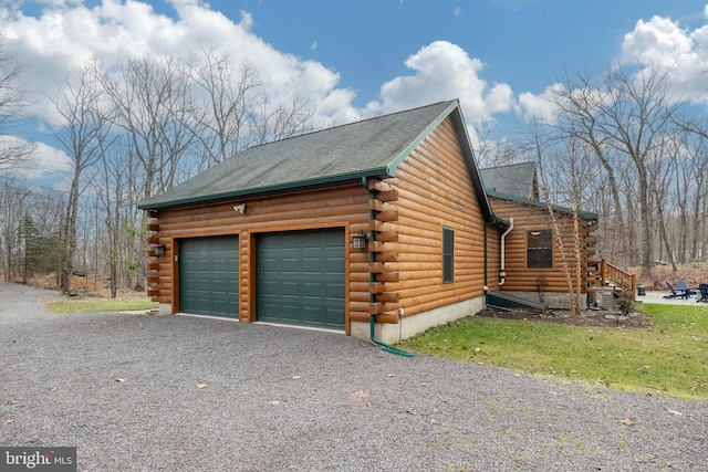 view of home's exterior featuring a garage and central AC