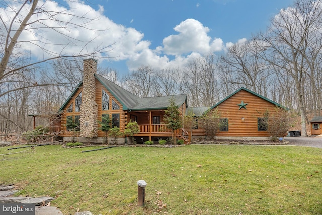 rear view of house with a yard