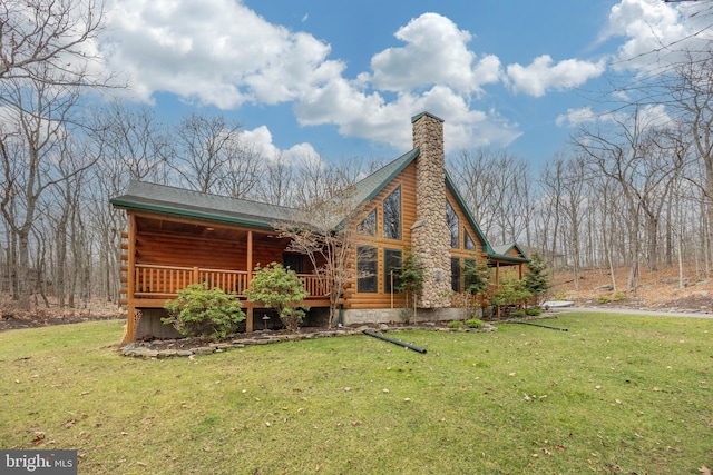 rear view of property with a lawn