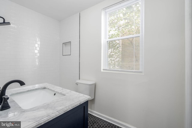 bathroom featuring a wealth of natural light, vanity, and toilet