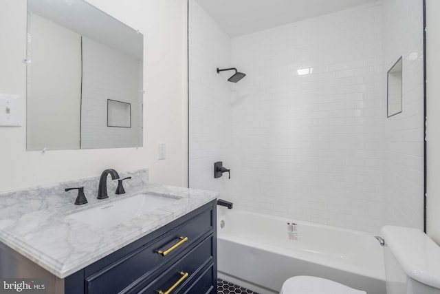 full bathroom with vanity, toilet, and tiled shower / bath