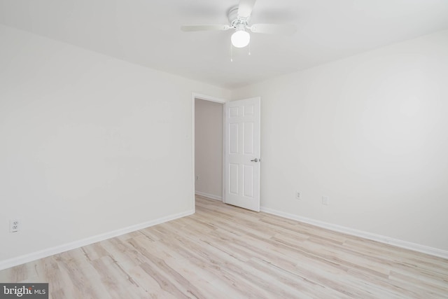 empty room featuring ceiling fan and light hardwood / wood-style flooring