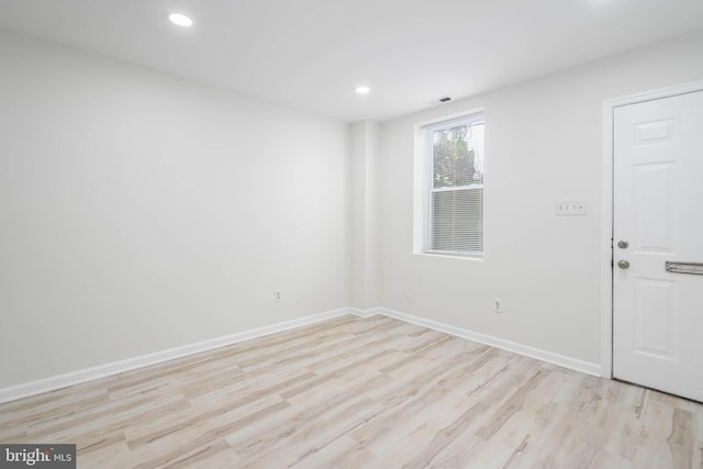 spare room featuring light wood-type flooring