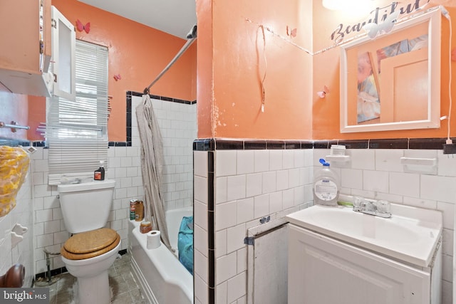 full bathroom featuring vanity, shower / bath combination with curtain, tile walls, and toilet