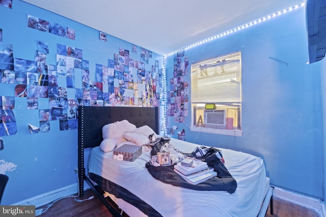 bedroom with hardwood / wood-style flooring and cooling unit