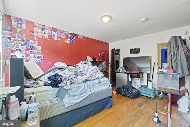 bedroom with hardwood / wood-style flooring