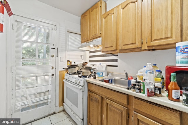 kitchen featuring white range with gas cooktop and light tile patterned flooring