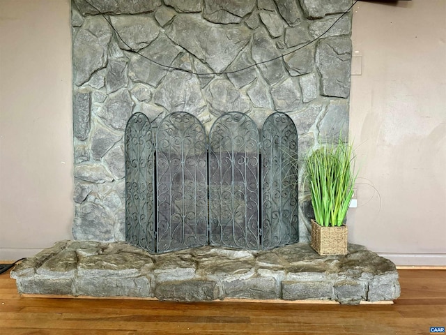 room details featuring a fireplace and wood-type flooring