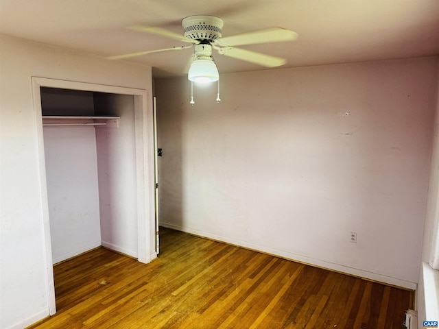 unfurnished bedroom featuring hardwood / wood-style floors, a closet, and ceiling fan