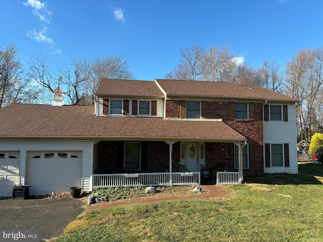 front facade with a front yard, a porch, and a garage