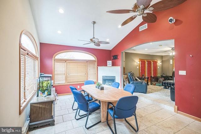 dining area featuring high vaulted ceiling and ceiling fan