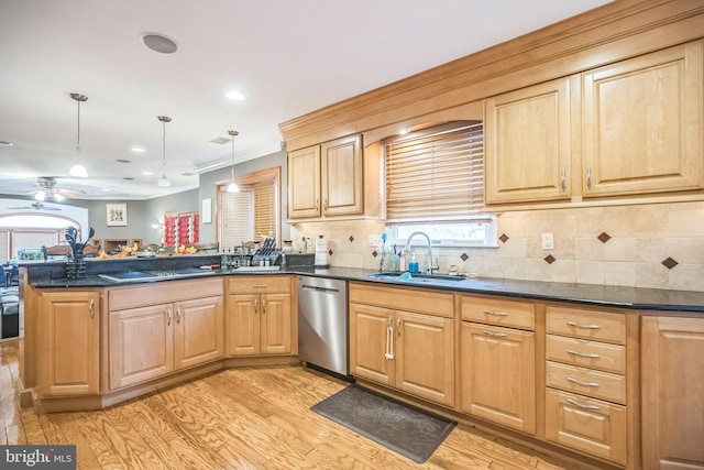 kitchen with kitchen peninsula, sink, pendant lighting, dishwasher, and light hardwood / wood-style floors