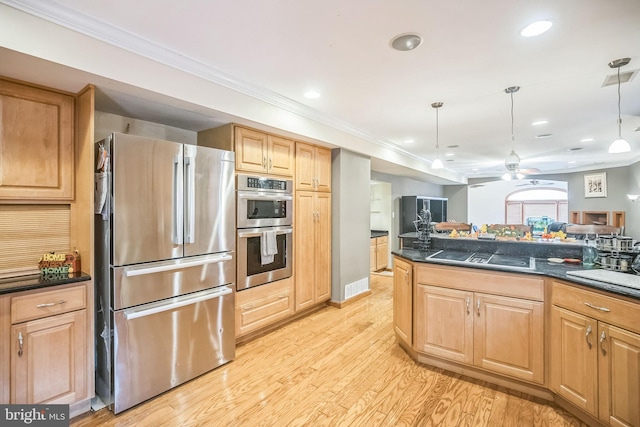 kitchen featuring appliances with stainless steel finishes, ornamental molding, ceiling fan, pendant lighting, and light hardwood / wood-style floors