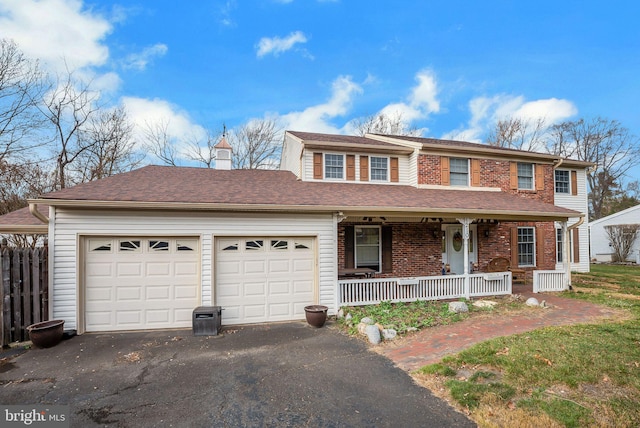 view of front of property featuring covered porch and a garage