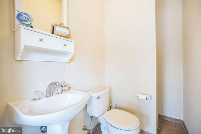 bathroom featuring tile patterned floors, toilet, and sink