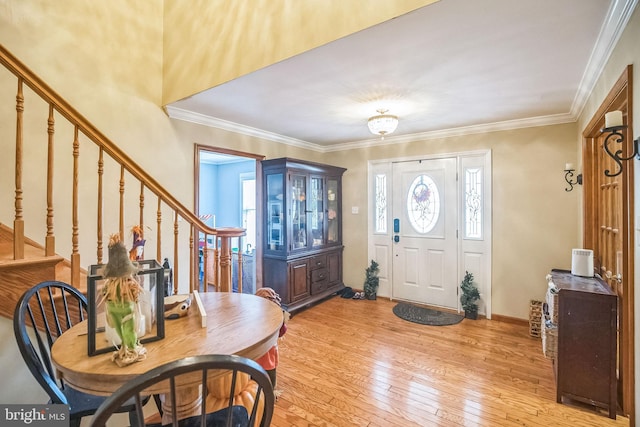 entryway with light wood-type flooring and ornamental molding