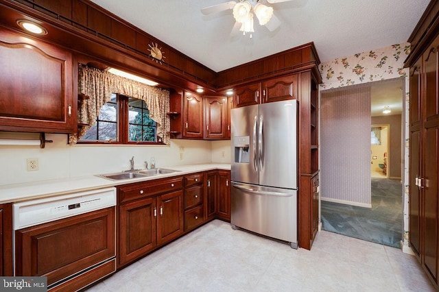 kitchen featuring dishwashing machine, a textured ceiling, ceiling fan, sink, and stainless steel fridge with ice dispenser