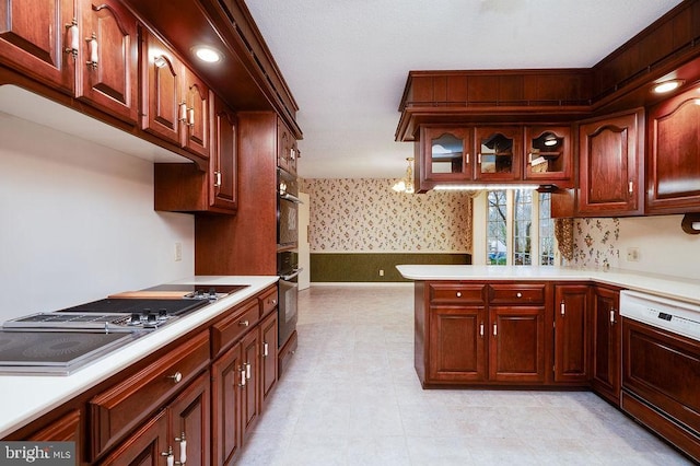 kitchen with white dishwasher, stainless steel gas stovetop, kitchen peninsula, and hanging light fixtures