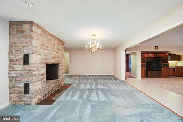 unfurnished living room featuring dark carpet, an inviting chandelier, and a stone fireplace