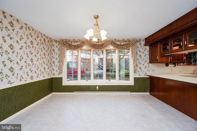 unfurnished dining area with baseboard heating and an inviting chandelier