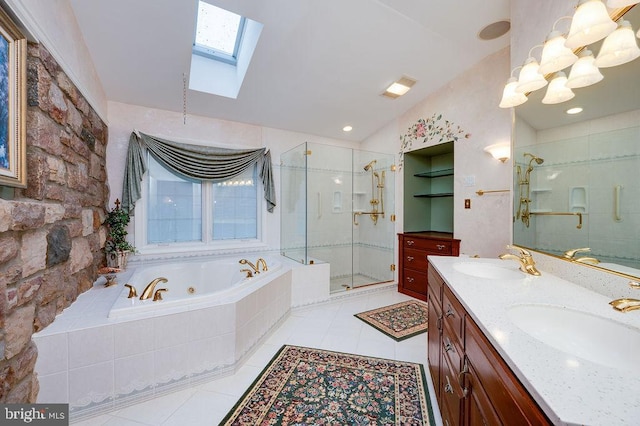 bathroom featuring tile patterned flooring, vanity, lofted ceiling with skylight, and independent shower and bath