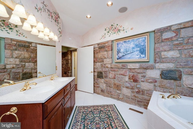 bathroom with tile patterned flooring, vanity, a relaxing tiled tub, and lofted ceiling