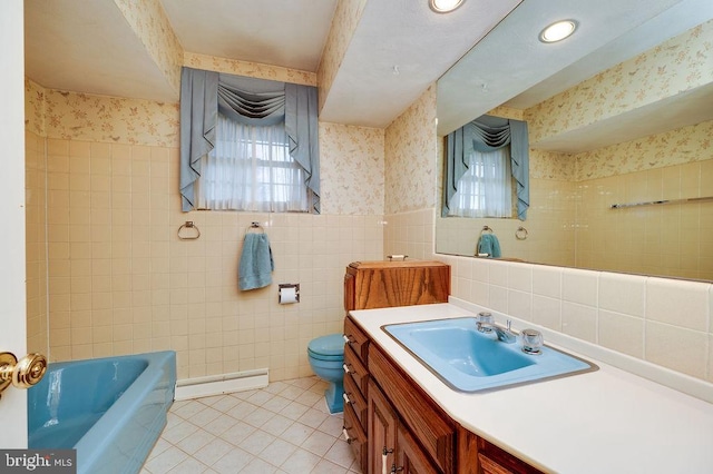 bathroom featuring tile patterned flooring, vanity, toilet, and tile walls