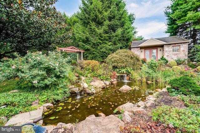 view of yard with a small pond