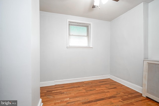 spare room with hardwood / wood-style flooring and ceiling fan