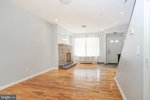 unfurnished living room featuring a fireplace and hardwood / wood-style floors