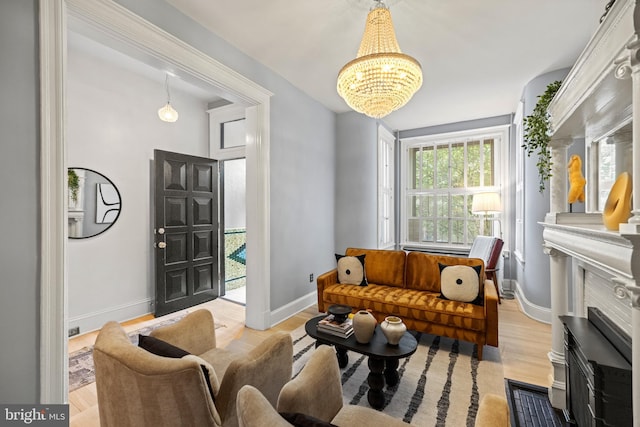 living room with a notable chandelier and light wood-type flooring