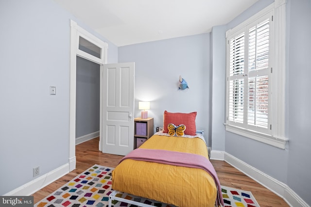 bedroom with hardwood / wood-style flooring