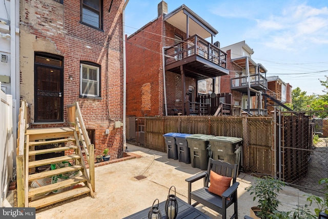 back of house featuring a balcony