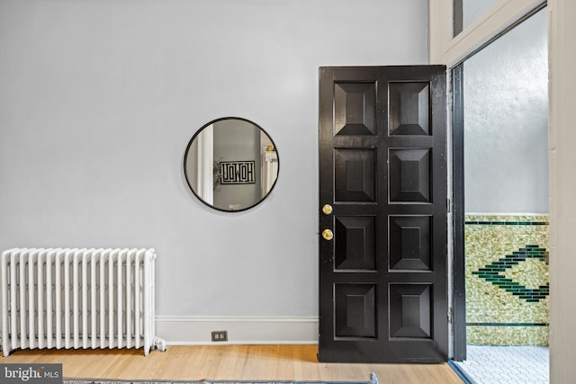 entrance foyer featuring hardwood / wood-style floors and radiator