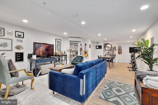 living room with light hardwood / wood-style floors and a wall mounted AC