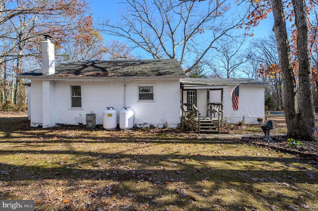 rear view of house with a lawn