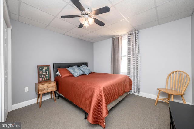 carpeted bedroom featuring a paneled ceiling and ceiling fan