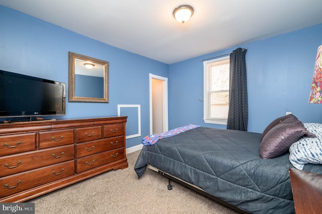 bedroom featuring light colored carpet