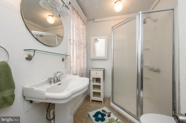 bathroom featuring tile patterned flooring, an enclosed shower, a textured ceiling, and toilet