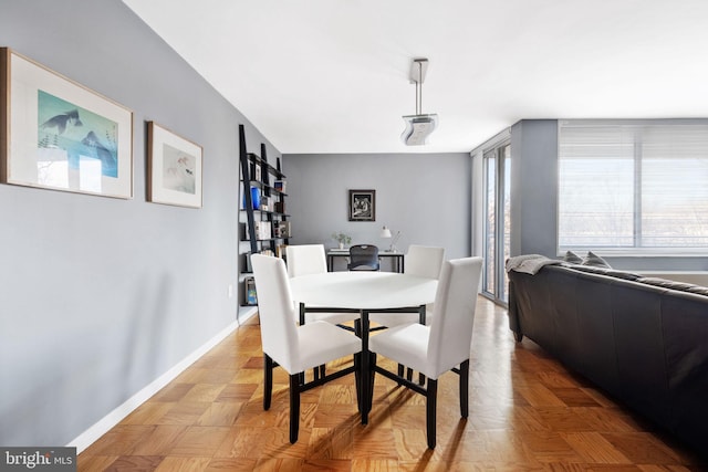 dining area featuring parquet floors