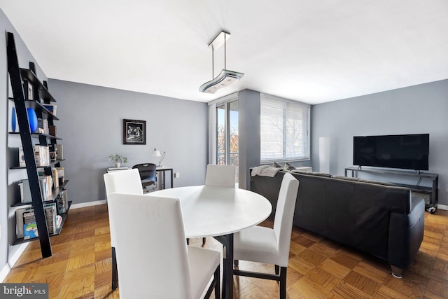 dining room featuring parquet floors