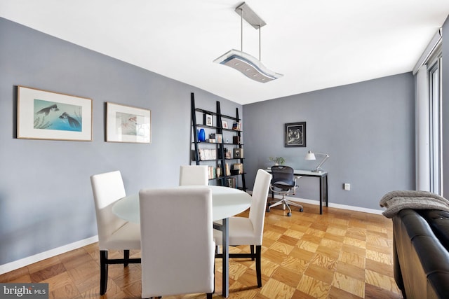 dining room featuring light parquet floors