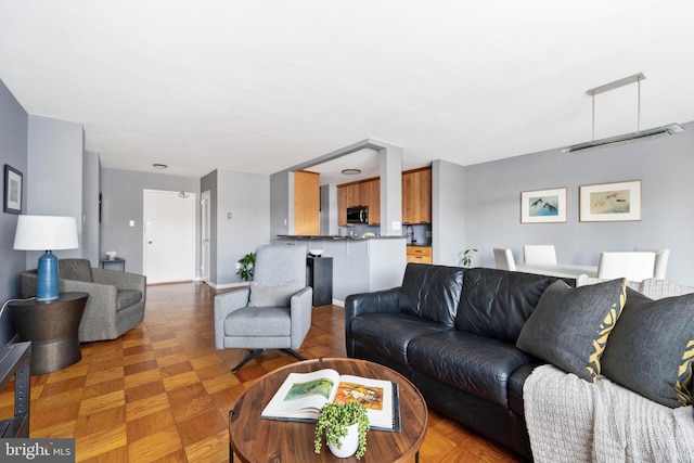 living room featuring parquet flooring