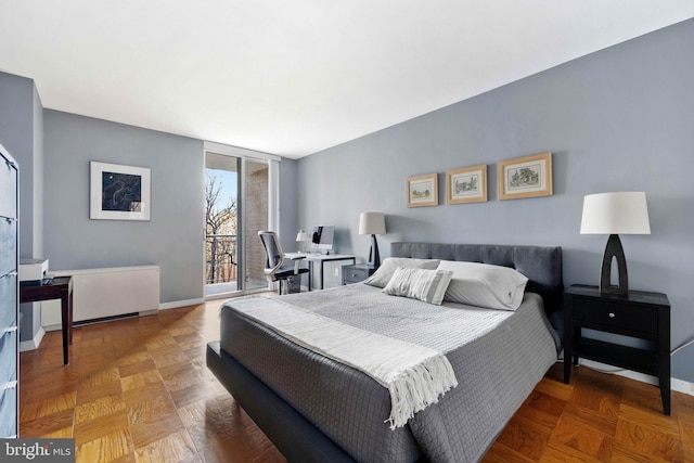 bedroom with access to exterior and parquet flooring