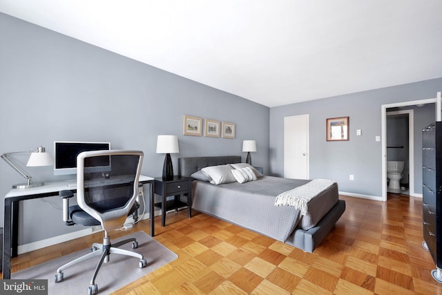 bedroom with ensuite bathroom and parquet flooring