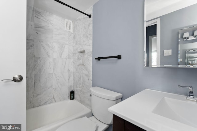 full bathroom with vanity, toilet, and tiled shower / bath