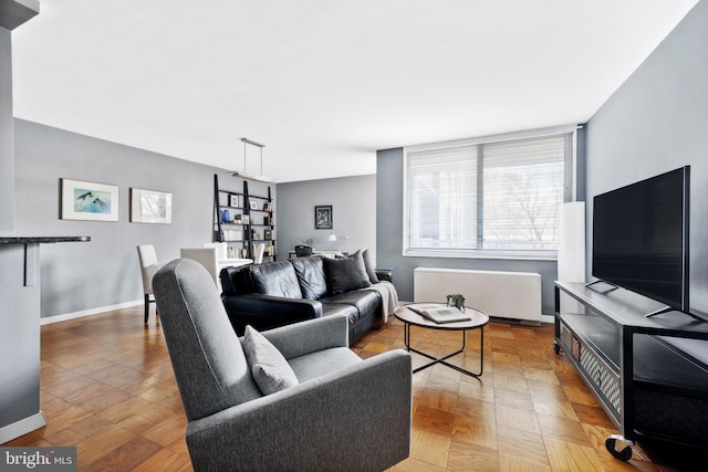 living room featuring radiator heating unit and hardwood / wood-style floors