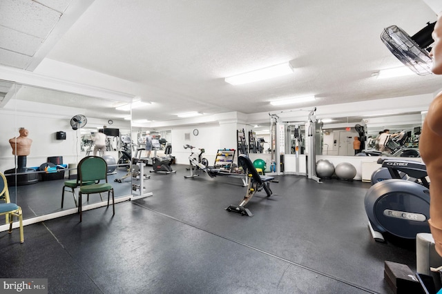 exercise room featuring a textured ceiling